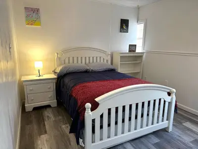 a bedroom with a white bed and two night stands at Welcome to Altamonte Springs! in Orlando