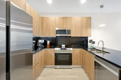 a kitchen with wooden cabinets and a stainless steel refrigerator at Relaxing Nature Escapade with Game Room in Orlando