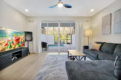 a living room with a couch and a flat screen tv at Relaxing Nature Escapade with Game Room in Orlando