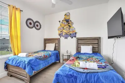 a bedroom with two beds and a flat screen tv at 8102-3-PP-Vacation getaway condo at Windsor in Kissimmee