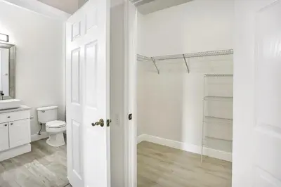 a white bathroom with a toilet and a sink at 8102-3-PP-Vacation getaway condo at Windsor in Kissimmee