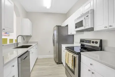 a kitchen with stainless steel appliances and white cabinets at 8102-3-PP-Vacation getaway condo at Windsor in Kissimmee