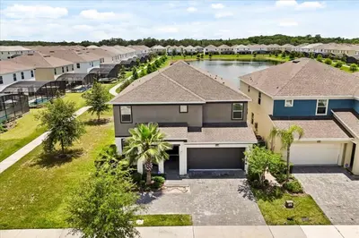 an aerial view of a house with a driveway at Summer Deal - Amazing 8BR Home with Private Pool! in Kissimmee