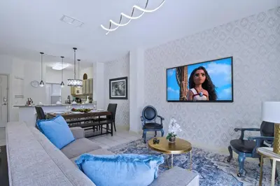 a living room with a couch and a tv on a wall at Cozy 3bd Townhouse Near Disney Encantada Resort in Kissimmee