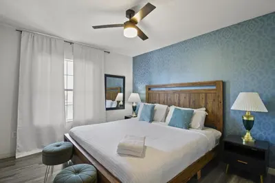 a bedroom with a large bed with a ceiling fan at Cozy 3bd Townhouse Near Disney Encantada Resort in Kissimmee