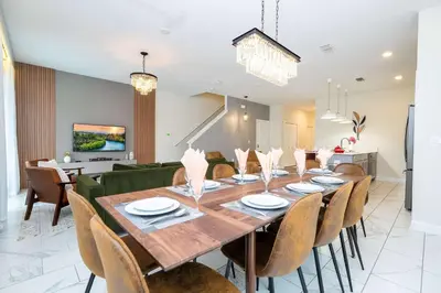 a dining room with a large wooden table and chairs at Vibrant 5Bd w Private Pool & Waterpark at Storey Lake 4811M in Kissimmee