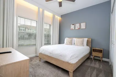 a bedroom with a bed and a window at Vibrant 5Bd w Private Pool & Waterpark at Storey Lake 4811M in Kissimmee