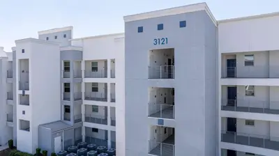 an aerial view of a white apartment building at Gorgeous 2Bd Close to Disney at Storey Lake Resort in Kissimmee