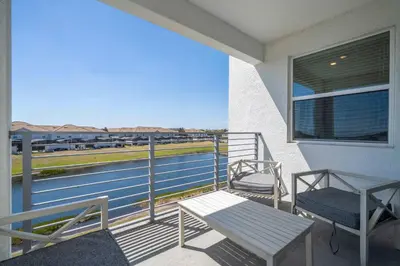a balcony with a bench and a view of the water at Gorgeous 2Bd Close to Disney at Storey Lake Resort in Kissimmee