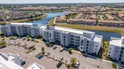 an aerial view of an apartment complex next to a river at Gorgeous 2Bd Close to Disney at Storey Lake Resort in Kissimmee