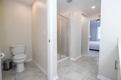 a bathroom with a toilet and a shower at Family Condo 2Bd Close to Disney at Storey Lake Resort in Kissimmee