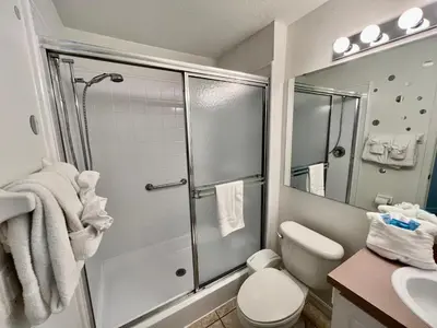 a bathroom with a shower and a toilet and a sink at Grand Emerald 3BR Townhouse Near Disney Parks in Kissimmee