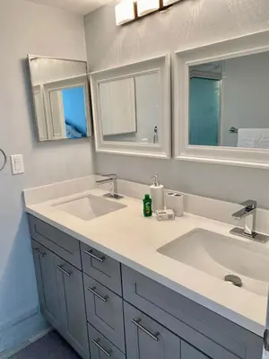 a bathroom with two sinks and two mirrors at Dream Superior 3BR Condo Near Disney Parks in Kissimmee