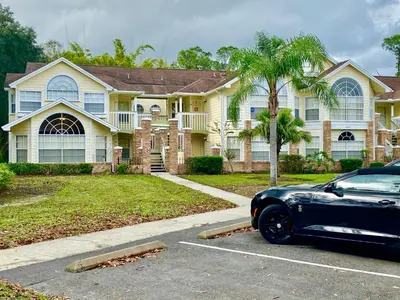a black car parked in front of a house at Disney Superior 3BR Condo Near Theme Parks in Kissimmee