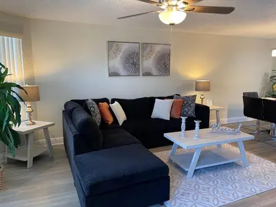 a living room with a couch and a table at Disney Superior 3BR Condo Near Theme Parks in Kissimmee