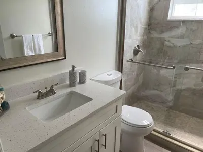 a bathroom with a sink and a toilet and a shower at Disney Superior 3BR Condo Near Theme Parks in Kissimmee