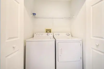 a white laundry room with a washer and dryer at Disney Superior 3BR Condo Near Theme Parks in Kissimmee