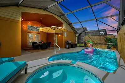 a swimming pool with a inflatablevisorangering a house at 5BR Cottage w Pool & Hot Tub Near Disney in Kissimmee