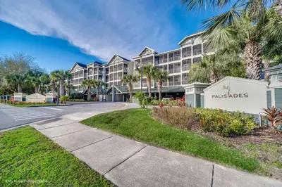 a street in front of a hotel with palm trees at Modern Pet-Friendly - 2BR Condo - 6 mins from Disney in Orlando
