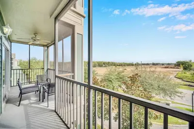 a balcony with a table and chairs and a view at Modern Pet-Friendly - 2BR Condo - 6 mins from Disney in Orlando