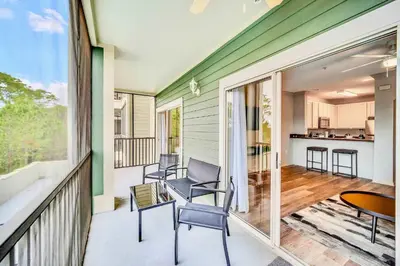 a porch with chairs and a table on a balcony at Condo with Pet-Friendly- Sauna & Pool in Orlando