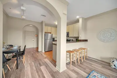 a kitchen and dining room with a table and chairs at Upstay - Condo - Hot Tub & Pool in Orlando