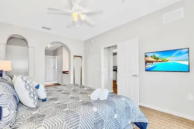 a white bedroom with a bed and a ceiling fan at Pet-Friendly Condo -Upstay Near Disney w Pool in Orlando