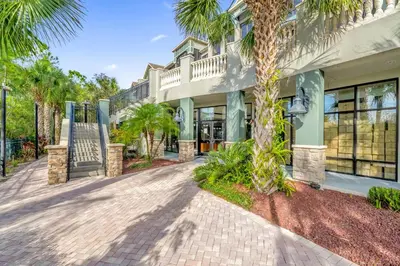 a house with palm trees and a driveway at Pet-Friendly Condo -Upstay Near Disney w Pool in Orlando