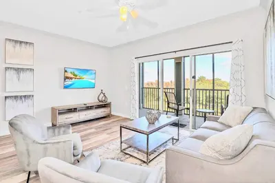 a living room with white furniture and a balcony at Pet-Friendly Condo -Upstay Near Disney w Pool in Orlando