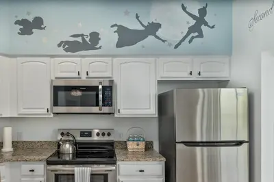 a kitchen with a stainless steel refrigerator and a microwave at Fabulous Condo at World Quest Resort Disney area in Orlando