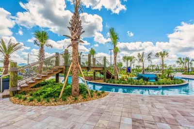 a pool at the resort with a slide and palm trees at Casa de 4 Quartos com Piscina Privativa in Kissimmee