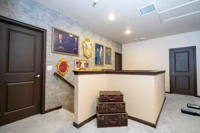a room with a counter with suitcases on a wall at NEW Paradiso Grande Disney Themed Cinema5827 in Orlando