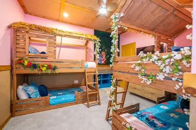 a room with two bunk beds and flowers at NEW Paradiso Grande Disney Themed Cinema5827 in Orlando