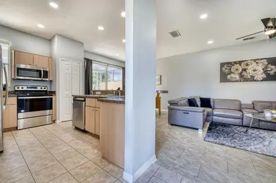 a kitchen and living room with a couch and a table at Stylish Townhome Close to Disney Parks in Kissimmee