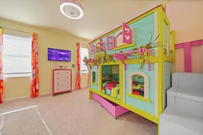 a childs bedroom with a colorful doll house at The Bling Estate in Kissimmee