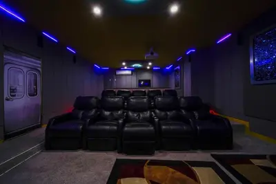 a room with a leather couch in a room with blue lights at The Bling Estate in Kissimmee