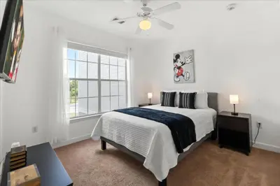 a white bedroom with a large bed and a window at 2 Bedrooms 2 Bathrooms Secret Lake 3176-204 in Kissimmee