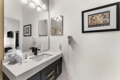 a bathroom with a sink and a large mirror at Windsor Palms Mickey Themed Condo, Pool, By Disney in Kissimmee