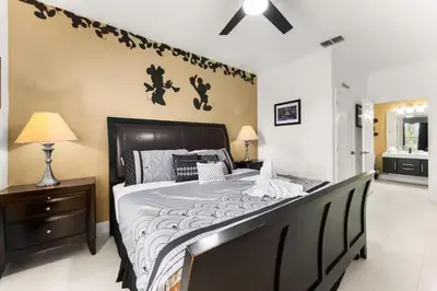 a bedroom with a large bed with a black headboard at Windsor Palms Mickey Themed Condo, Pool, By Disney in Kissimmee