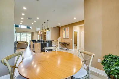 a dining room with a wooden table and chairs at Less Than 2 Mi to WDW Attractions Luxe Family Getaway! in Orlando