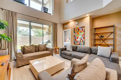 a living room with a couch and a table at Less Than 2 Mi to WDW Attractions Luxe Family Getaway! in Orlando