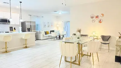 a kitchen and living room with a table and chairs at Entire House in Orlando close to All Parks in Orlando