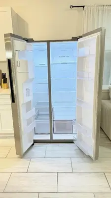 a refrigerator with its doors open in a kitchen at Entire House in Orlando close to All Parks in Orlando