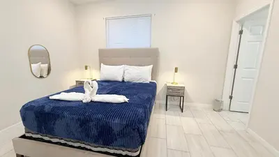 a bedroom with a blue bed with towels on it at Entire House in Orlando close to All Parks in Orlando