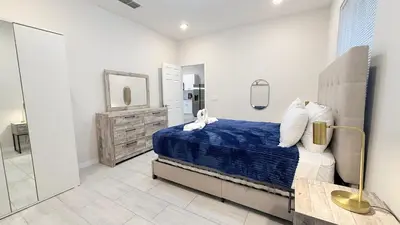 a bedroom with a blue bed and a mirror at Entire House in Orlando close to All Parks in Orlando