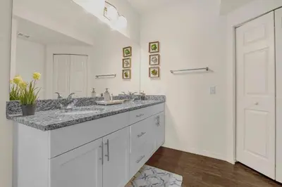 a white bathroom with a sink and a mirror at Dluxx Perfect Townhouse next to Disney Parks 3204 in Kissimmee