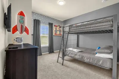 a bedroom with a bunk bed with a rocket on the wall at Dluxx Perfect Townhouse next to Disney Parks 3204 in Kissimmee