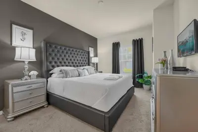 a bedroom with a large bed and a window at Dluxx Perfect Townhouse next to Disney Parks 3204 in Kissimmee
