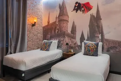 a bedroom with two beds with a castle mural on the wall at Amazing 03 Bedrooms 03 Baths Sleeps 08 in Kissimmee