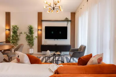 a living room with a couch and a tv at Amazing 03 Bedrooms 03 Baths Sleeps 08 in Kissimmee
